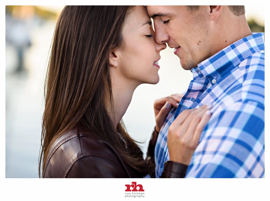 An Engaged couple embrace along the delaware river.